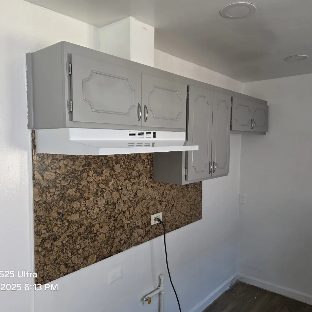 Finished gray cabinets with range hood