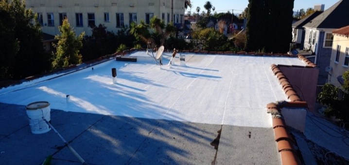 Roof with white elastomeric coating